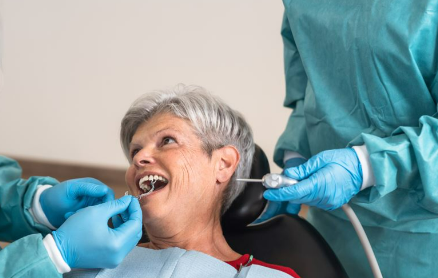 A woman gets a dental check-up, focusing on restorative options for seniors.